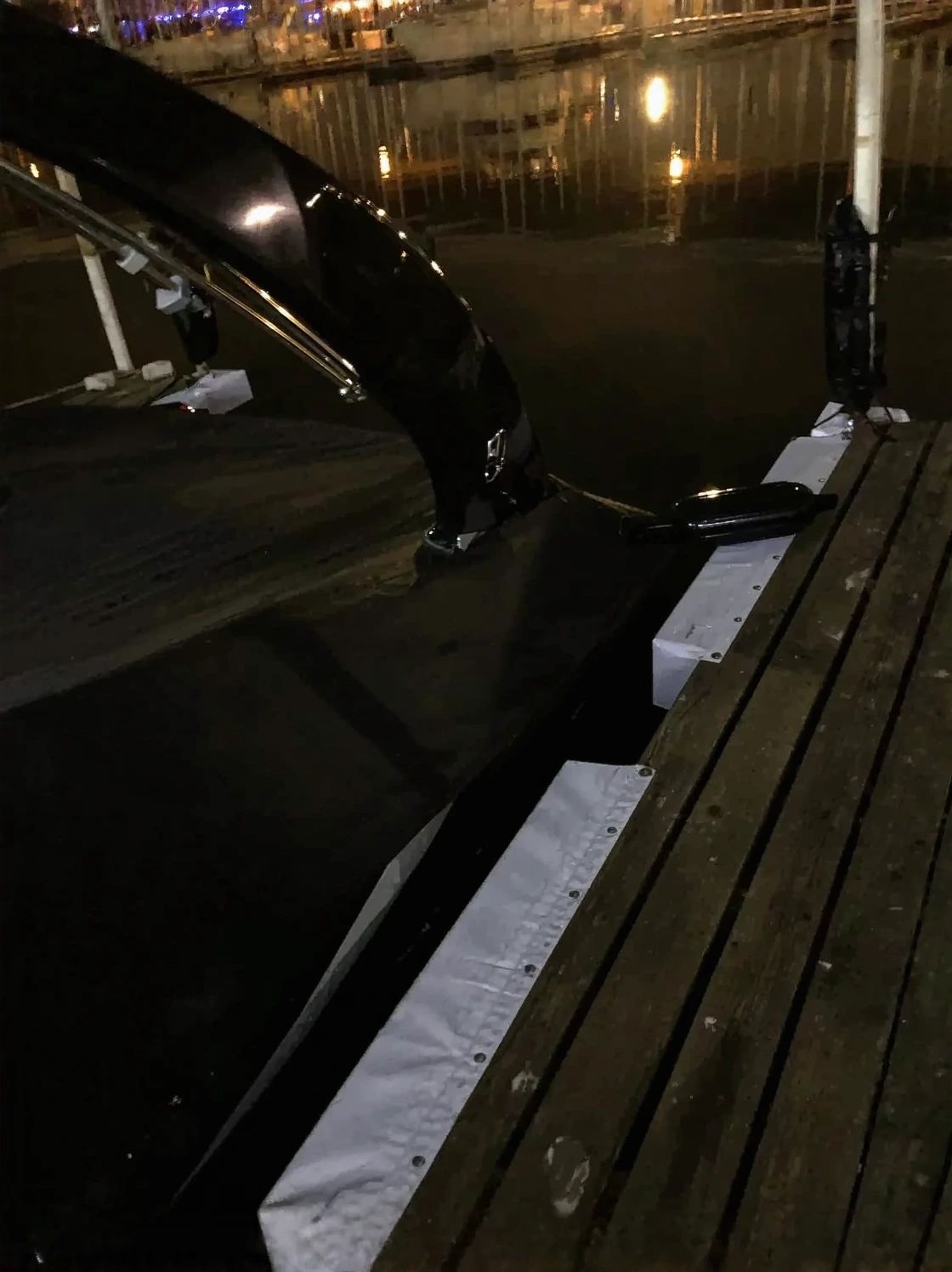 Customer photo of installed dock bumpers and cleats mounted on wooden dock pilings