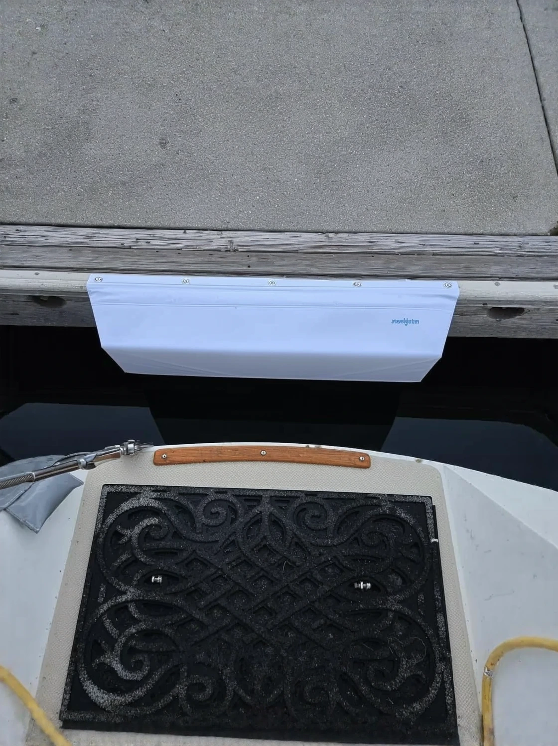 Customer photo of dock bumpers and cleats installed on boat dock showing weathered condition after hurricane season