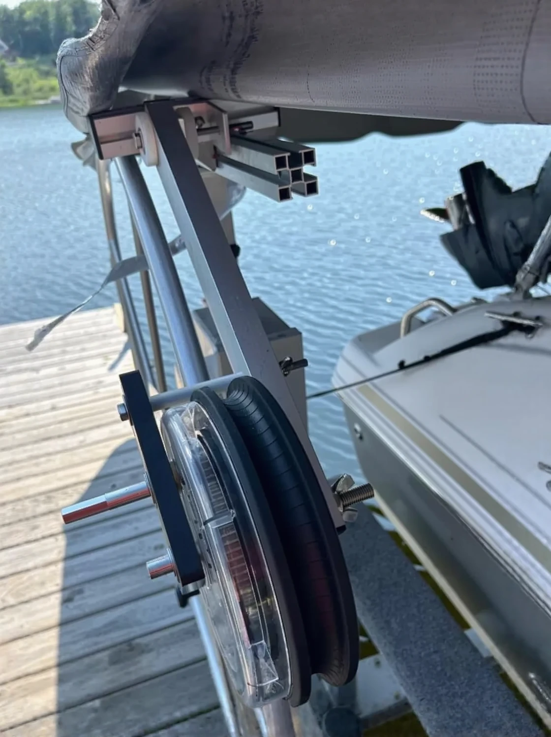 Customer photo of vertical boat lift installed at dock showing weight capacity and structural support