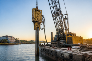 The Machines That Pound Your Dock Into the Lakebed: Hydraulic vs. Vibratory Pile Hammers Explained